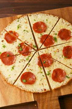 a pepperoni and cheese pizza on a wooden cutting board