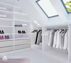 a white closet filled with lots of shoes and clothes hanging on shelves in front of a skylight