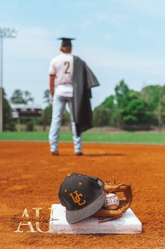 a baseball cap and glove sitting on top of a base