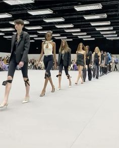 several models walk down the runway at a fashion show