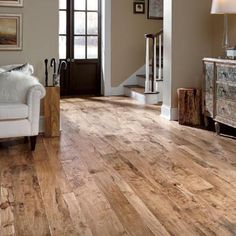 a living room with wood floors and white furniture