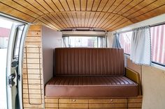 the inside of an rv with a couch and window in it's side wall