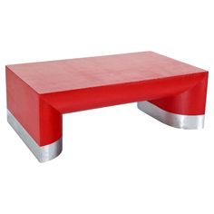 a red coffee table sitting on top of a white floor