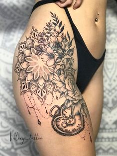 a close up of a woman's thigh with flowers on it