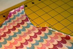 a piece of fabric sitting on top of a cutting board