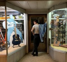 a man standing in front of a store window