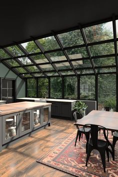 an open kitchen and dining room with large windows