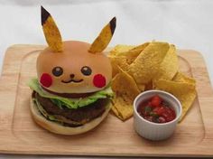 a wooden tray topped with a sandwich and chips