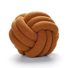 a ball of yarn sitting on top of a white surface with no one around it