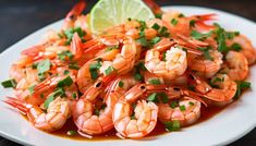 a white plate topped with cooked shrimp and garnished with cilantro sauce