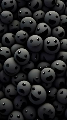 many black balls with smiley faces on them