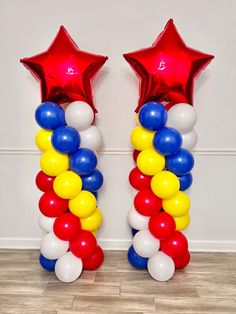 two red, white and blue balloons are next to each other in the shape of stars