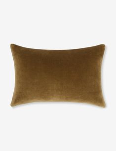 a brown velvet pillow on a white background