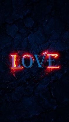 the word love is lit up in red and blue neon lights on a dark background