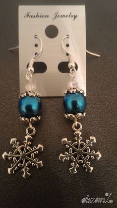 the earrings are blue and have snowflakes on them