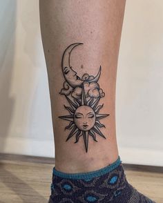 a woman's foot with a sun and moon tattoo on her left side leg