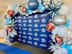 balloon arch decorated with footballs, stars and balloons