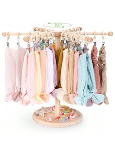 a rack with several different colored scarves hanging from it's hooks on a white background