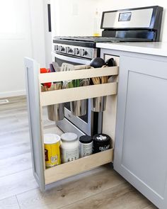 an open drawer in the middle of a kitchen