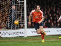 two soccer players are running after the ball