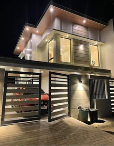 a modern house at night with the lights on