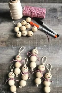 several wooden beads are tied to string and next to some spools of thread