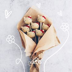 a bouquet of hello kitty cookies wrapped in brown paper