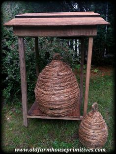 a wooden table with two large baskets on the top and one smaller basket below it