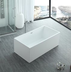 a large white bath tub sitting next to a window