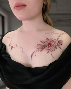 a woman with a flower tattoo on her chest