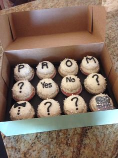 a box filled with cupcakes covered in frosting that say prom and yes