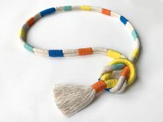 multicolored necklace with tassels on white background