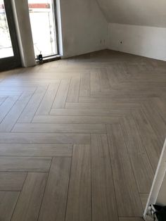 an empty room with wood flooring in it