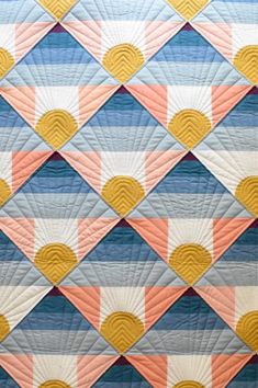 a quilt made with different colors and shapes