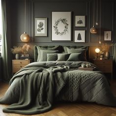 a bed with green comforter and pillows in a room next to pictures on the wall