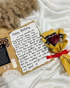 a teddy bear is laying next to a birthday card