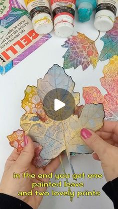 someone is painting leaves with acrylic paint on the paper and then using glue