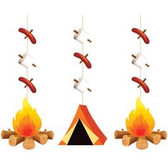 three hot dogs hanging from strings over a campfire