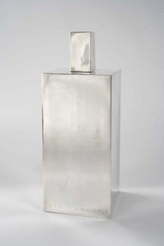 a silver square shaped object on a white background