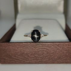 Band : Goldsmith Jewellers Material : 14K Yellow Gold Gemstone : Natural Black Star Black Star Stone Weight : 2.31 Carat Black Star Stone Size : 9.07 x 7.07 MM Secondary Stone : Natural Diamond Diamond Stone Weight : 0.06 Carat Diamond Stone Size : 1.90 MM  Gross Weight : 1.920 Gm Approx.... Stone Shape : Oval and Round Stone Color : Black and White  Band Color : Yellow Gold Ring Size : All Size Available Made to Order Please Give Your Opinion or Feedback About The Product https://www.etsy.com/in-en/your/shops/GoldsmithJewellers/onboarding/listings/create Star Ring Engagement, White Band, Star Ring, Black Star, Diamond Stone, Yellow Gold Rings, Promise Rings, Anniversary Rings, Ring Gift