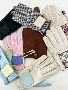 many different types of gloves on a white surface