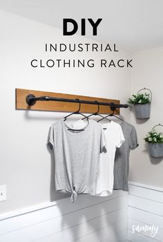 an industrial clothing rack with t - shirts hanging on it and the text diy industrial clothing rack