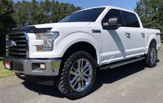 a white truck parked on the side of a road