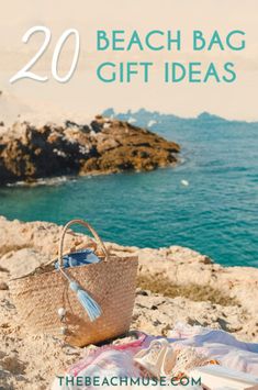 a beach bag sitting on top of a rock next to the ocean with text overlay reading 20 beach bag gift ideas