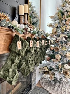 stockings hung on the mantle with christmas decorations