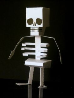 a paper skeleton is standing in the dark