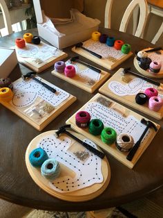 the table is covered with crafting supplies and paper work on it's trays