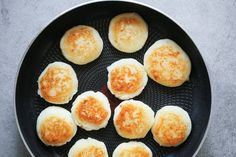 some fried eggs in a frying pan on a table