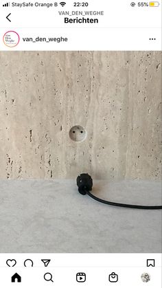 a light that is on the side of a wall next to a black cord and plugged into an outlet