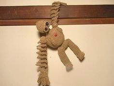 a crocheted stuffed animal hanging on a wall